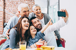 Smiling family taking a selfie photograph together